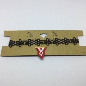 Crocheted ribbon necklace with beaded charm